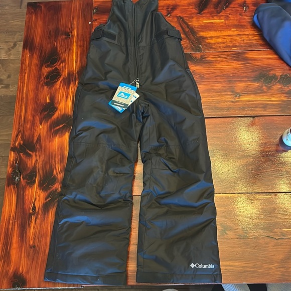 Brand new with tags, black snow bibs. Size youth small. - Picture 1 of 6